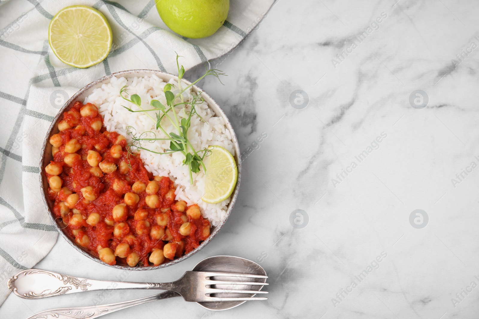 Photo of Delicious chickpea curry with rice served on white marble table, flat lay. Space for text