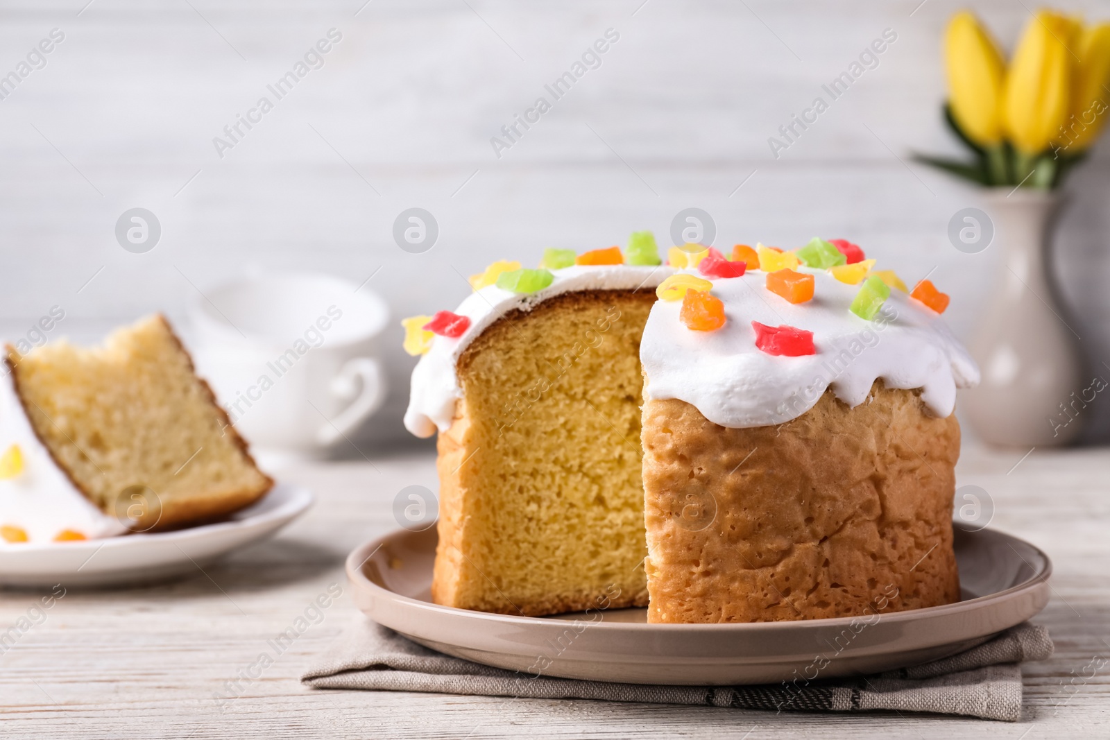 Photo of Traditional Easter cake on white wooden table. Space for text