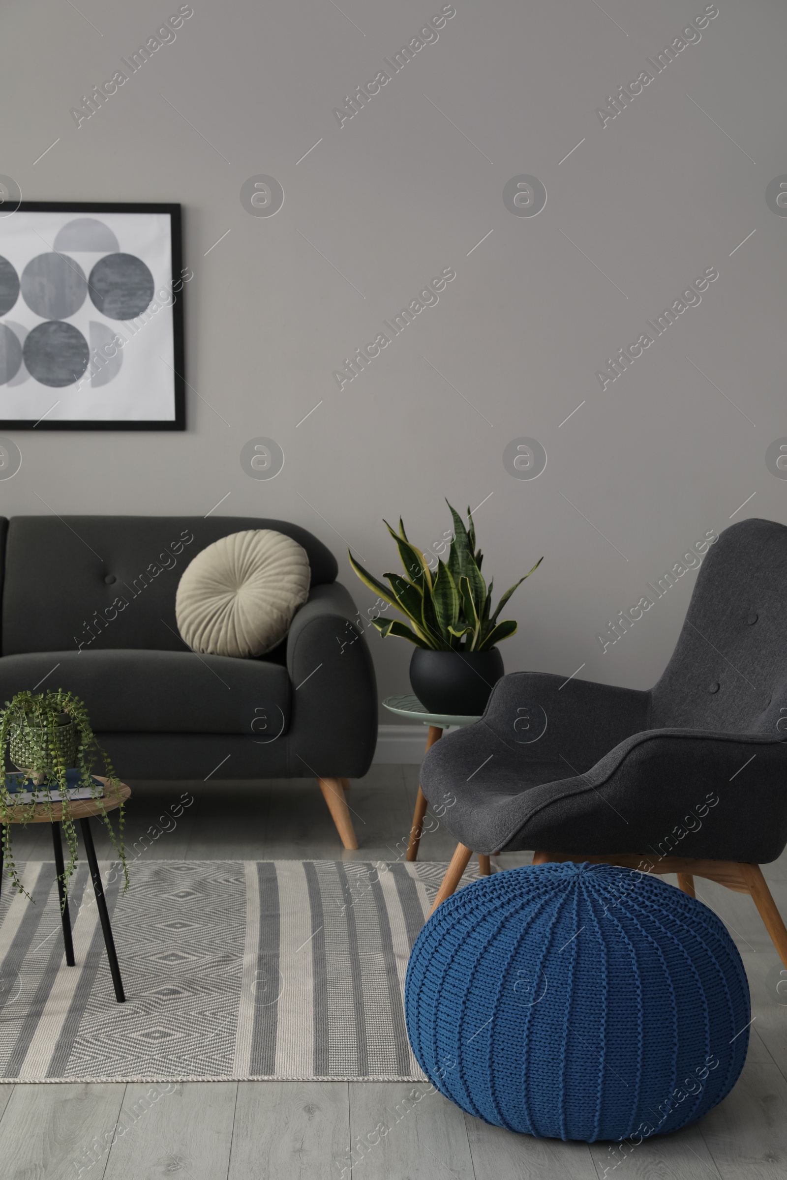 Photo of Stylish comfortable poufs and sofa in room. Home design