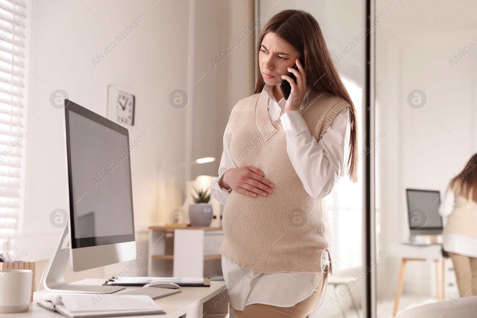 Photo of Tired pregnant woman working at home. Maternity leave