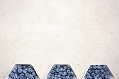 Photo of Flat lay composition with fresh blueberries and space for text on table