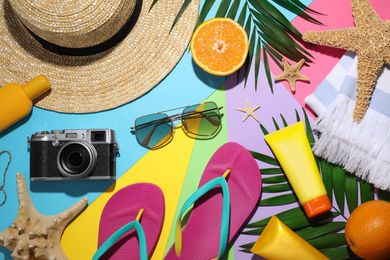 Flat lay composition with beach objects on color background