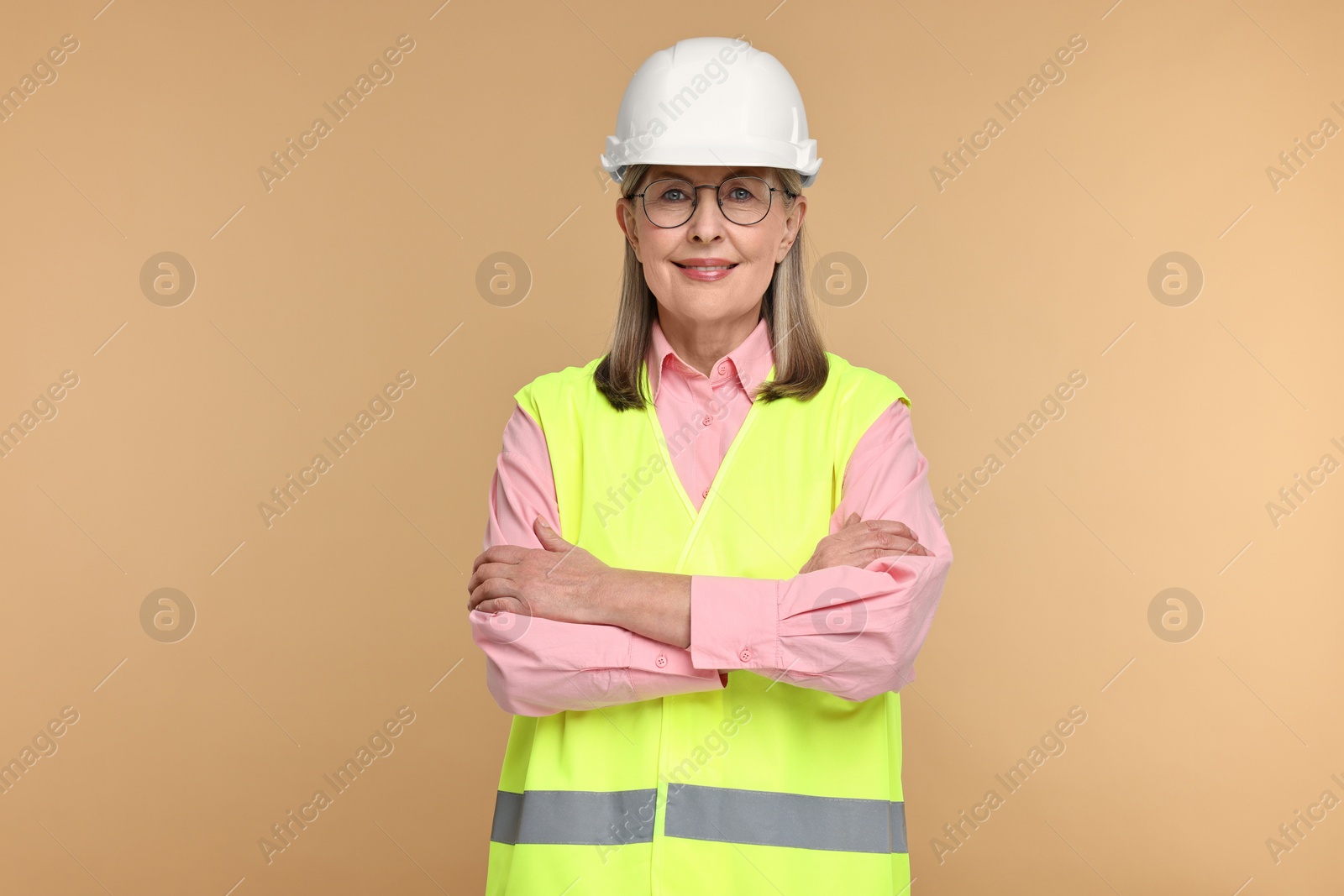 Photo of Portrait of architect in hard hat on beige background