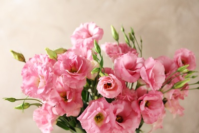 Photo of Beautiful bouquet of Eustoma flowers on color background, close up view