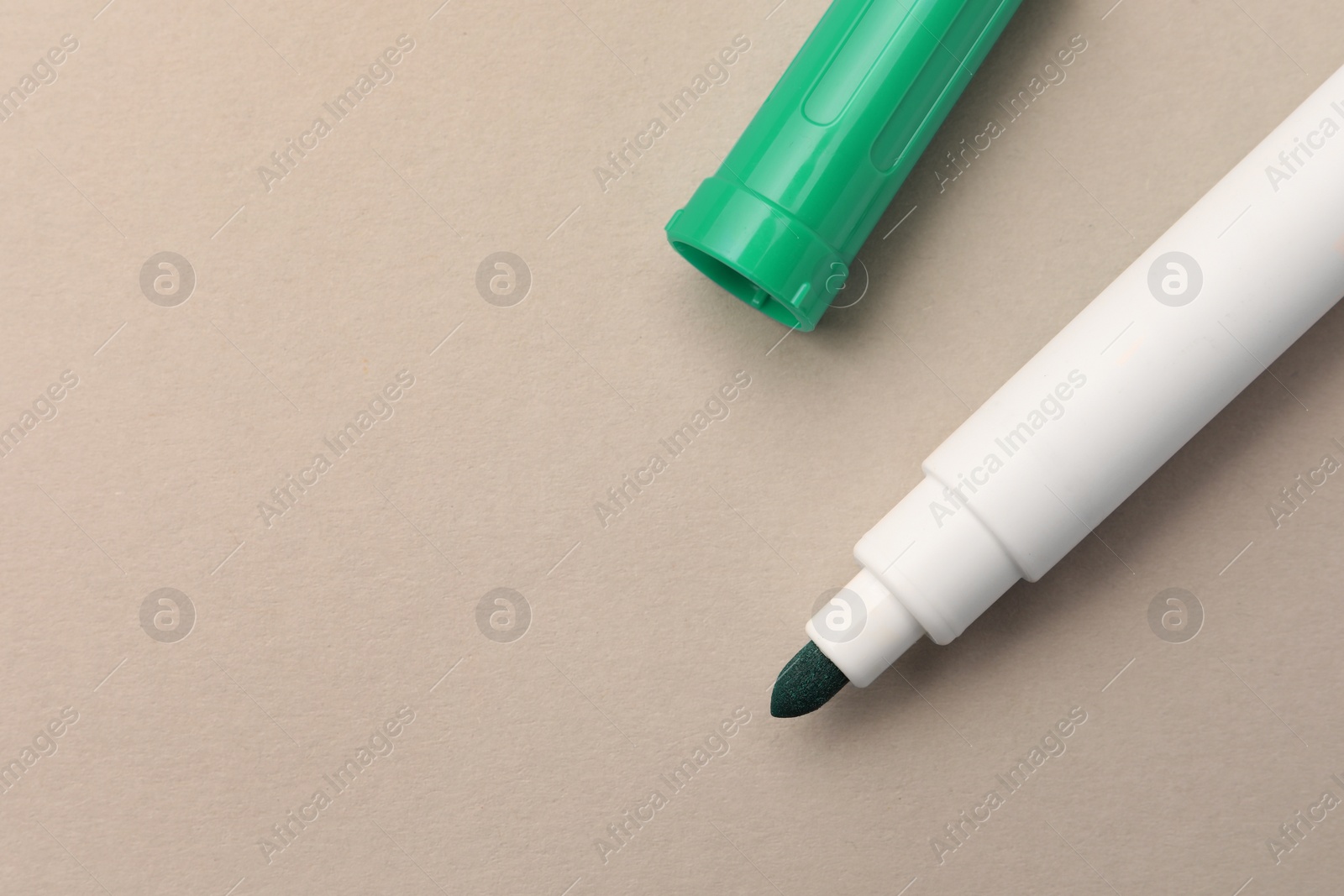 Photo of Bright green marker on beige background, flat lay. Space for text