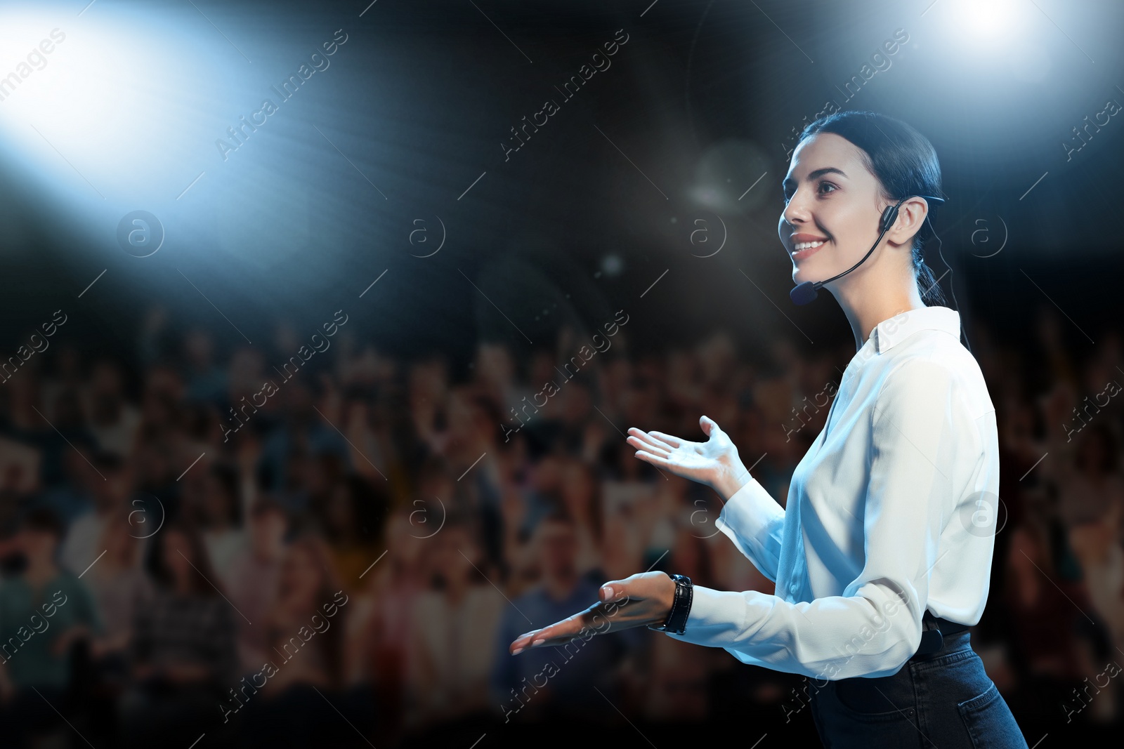 Image of Motivational speaker with headset performing on stage