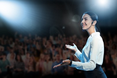 Image of Motivational speaker with headset performing on stage