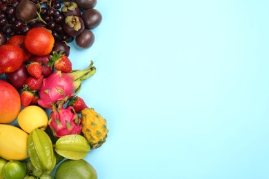 Photo of Many different delicious exotic fruits on light blue background, flat lay. Space for text