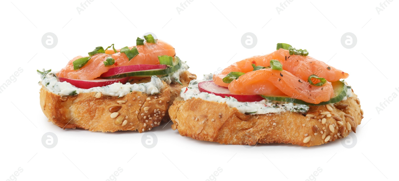 Photo of Tasty canapes with salmon, cucumber, radish and cream cheese isolated on white