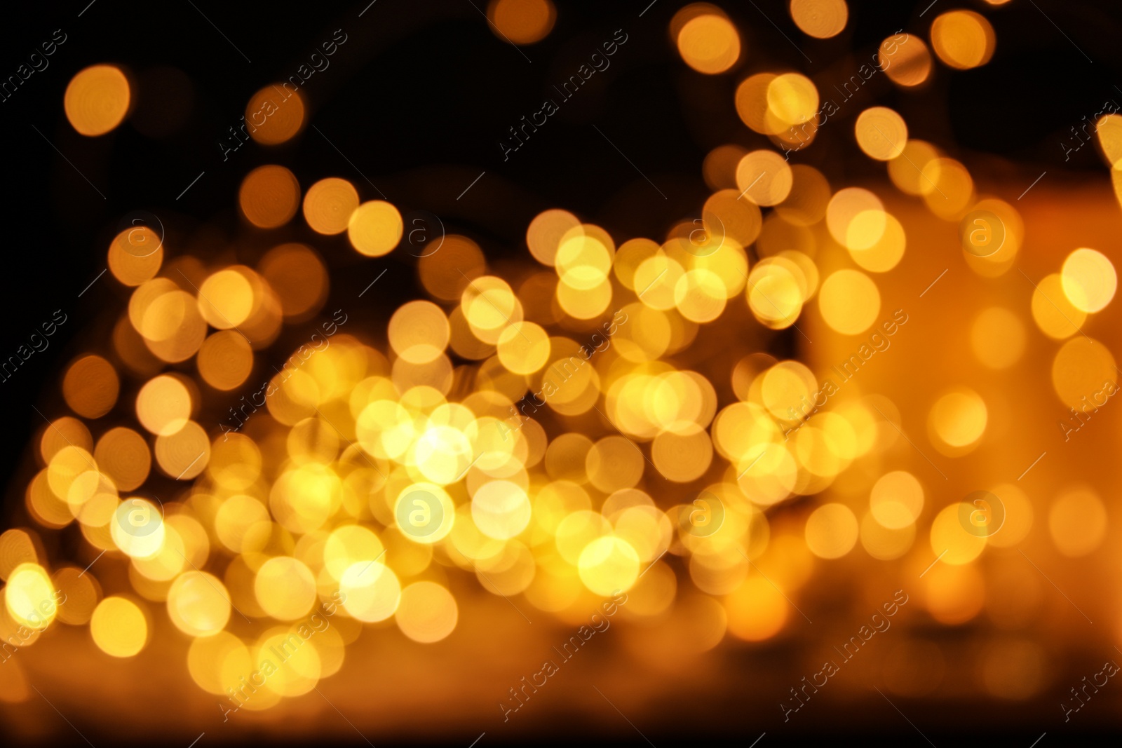 Photo of Gold glitter with bokeh effect on dark background