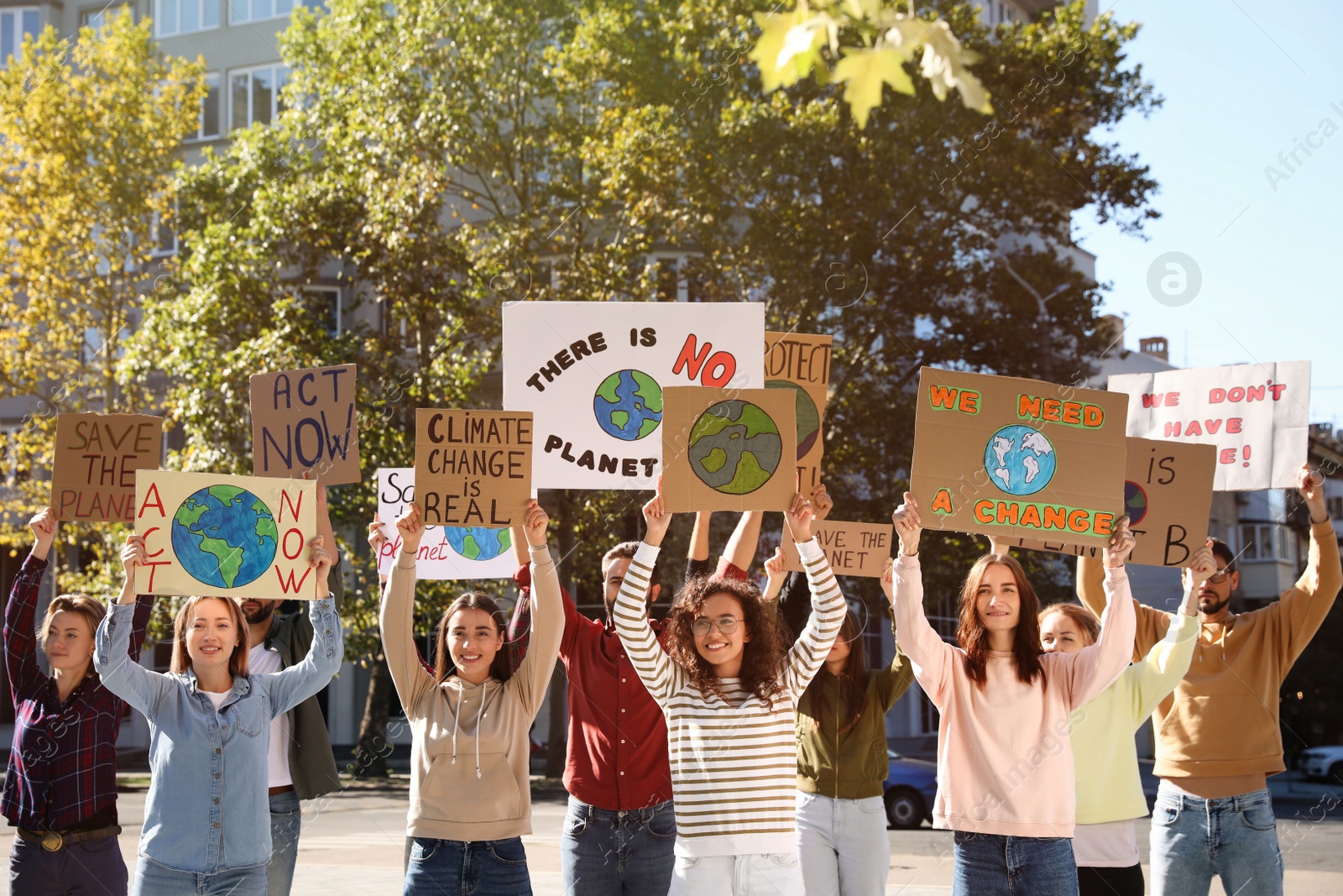 Photo of Group of people with posters protesting against climate change on city street