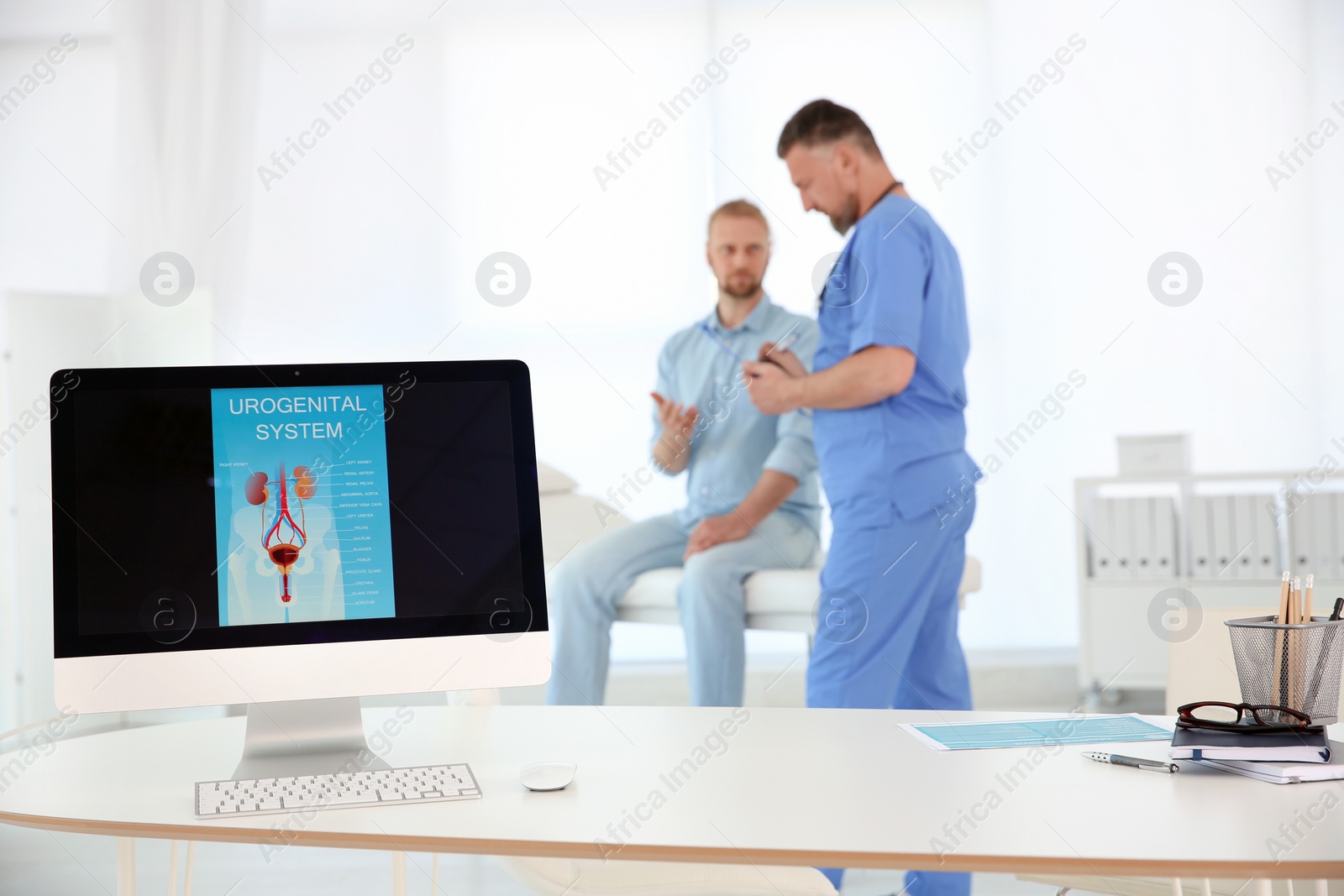 Photo of Computer monitor with picture of urogenital system and people on background