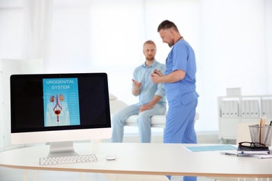 Photo of Computer monitor with picture of urogenital system and people on background