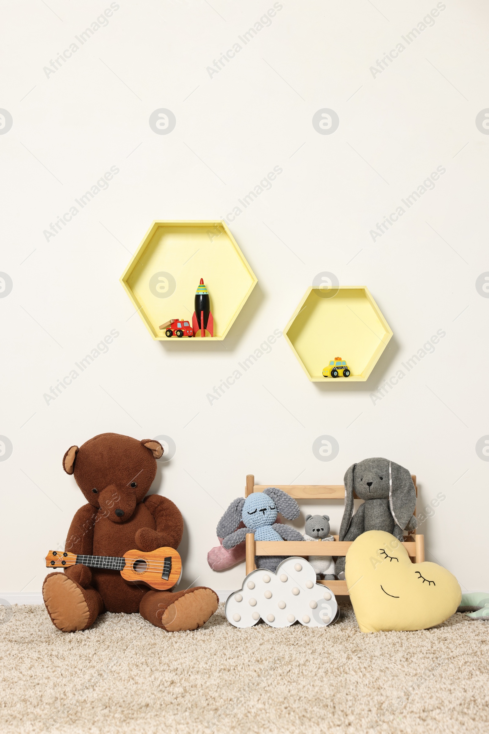 Photo of Soft toys and shelfs in beautiful children's room