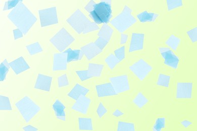 Image of Bright confetti falling on gradient yellow background
