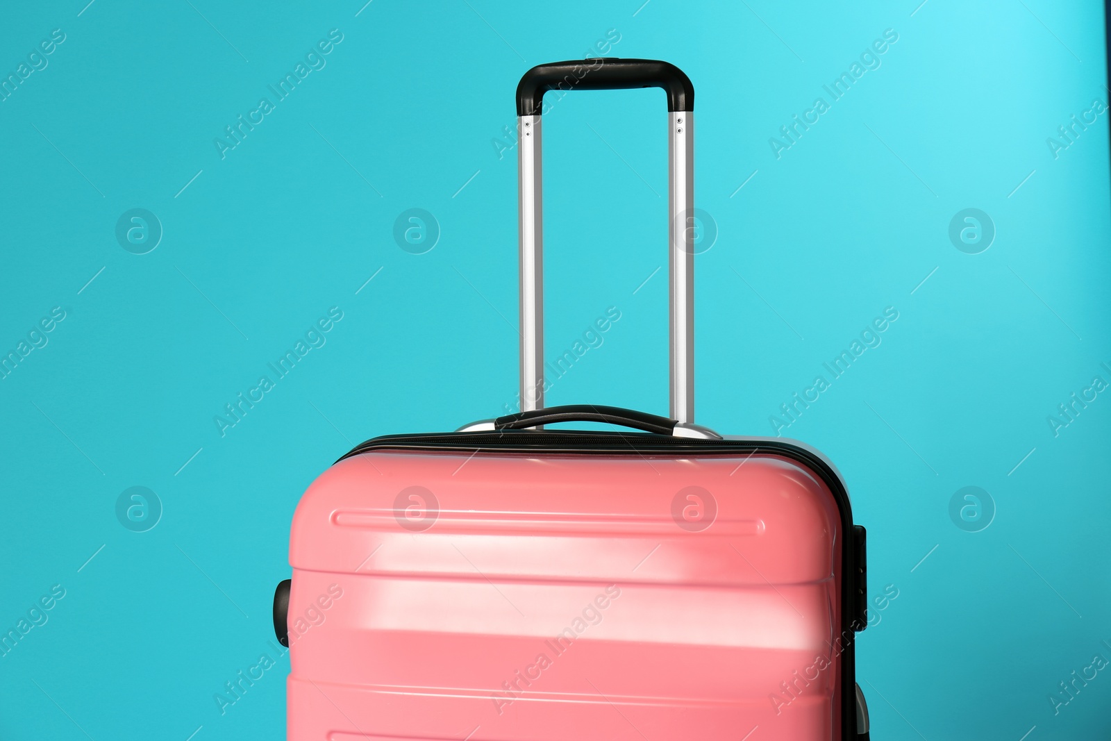 Photo of Stylish carry on suitcase on color background