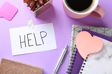 Flat lay composition with stationery, cup of coffee and note HELP on color background