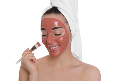 Photo of Woman applying pomegranate face mask on white background