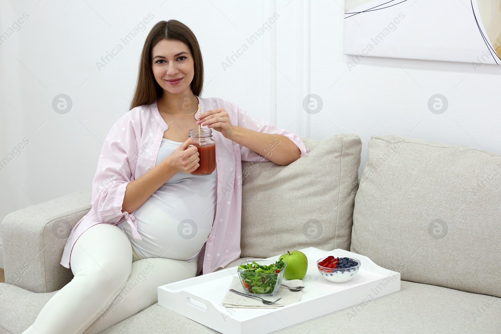 Photo of Pregnant woman eating breakfast at home. Healthy diet