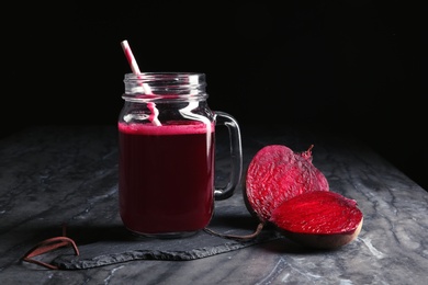 Photo of Mason jar of beet smoothie on table