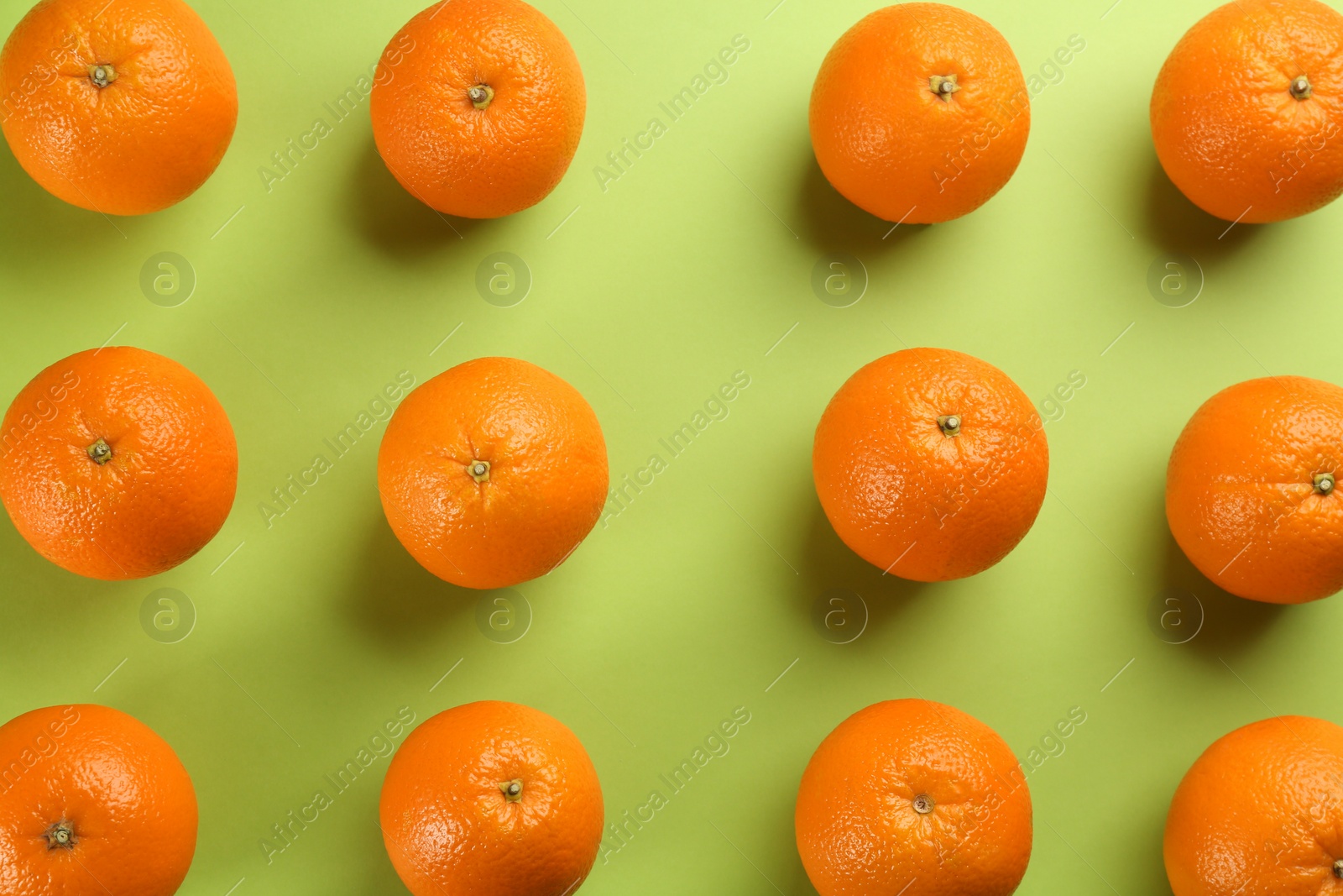 Photo of Delicious oranges on green background, flat lay