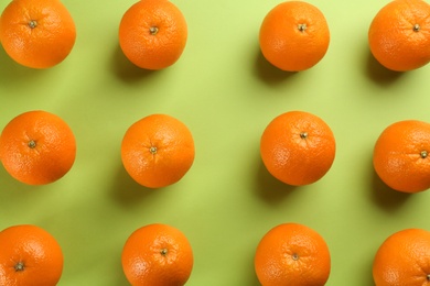Delicious oranges on green background, flat lay