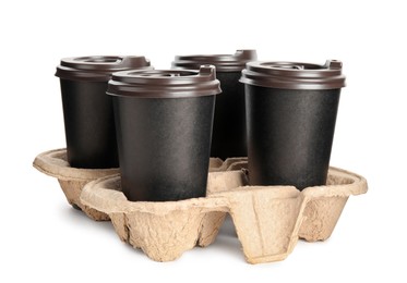 Takeaway paper coffee cups in cardboard holder on white background