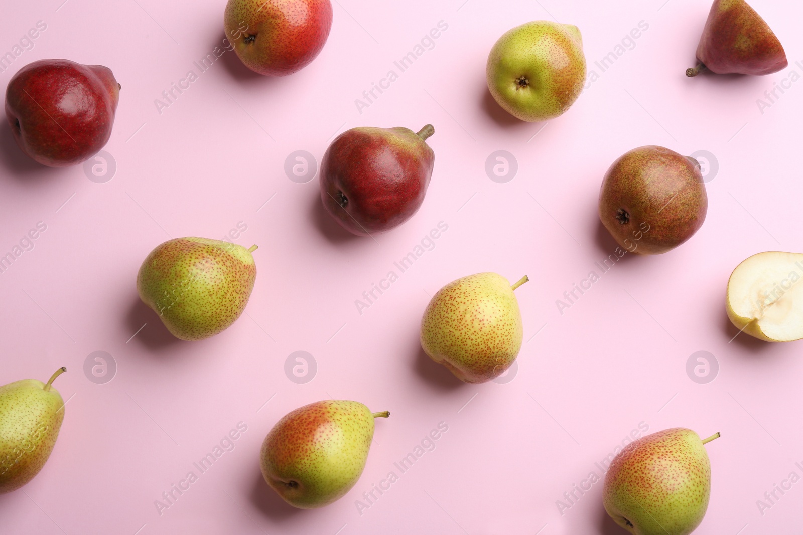 Photo of Ripe juicy pears on pink background, flat lay