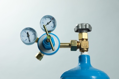 Photo of Pressure gauge of medical oxygen tank on light grey background, closeup