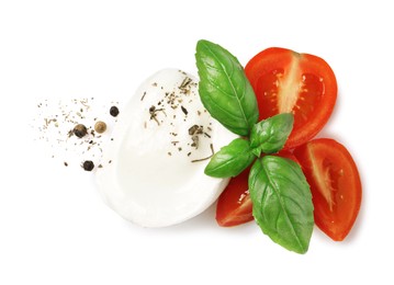 Photo of Delicious mozzarella with tomatoes and basil leaves on white background, top view