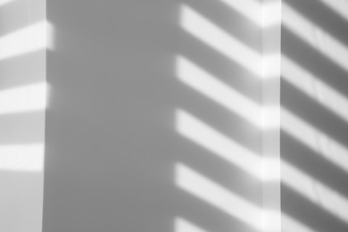 Image of Light and shadows falling on white wall