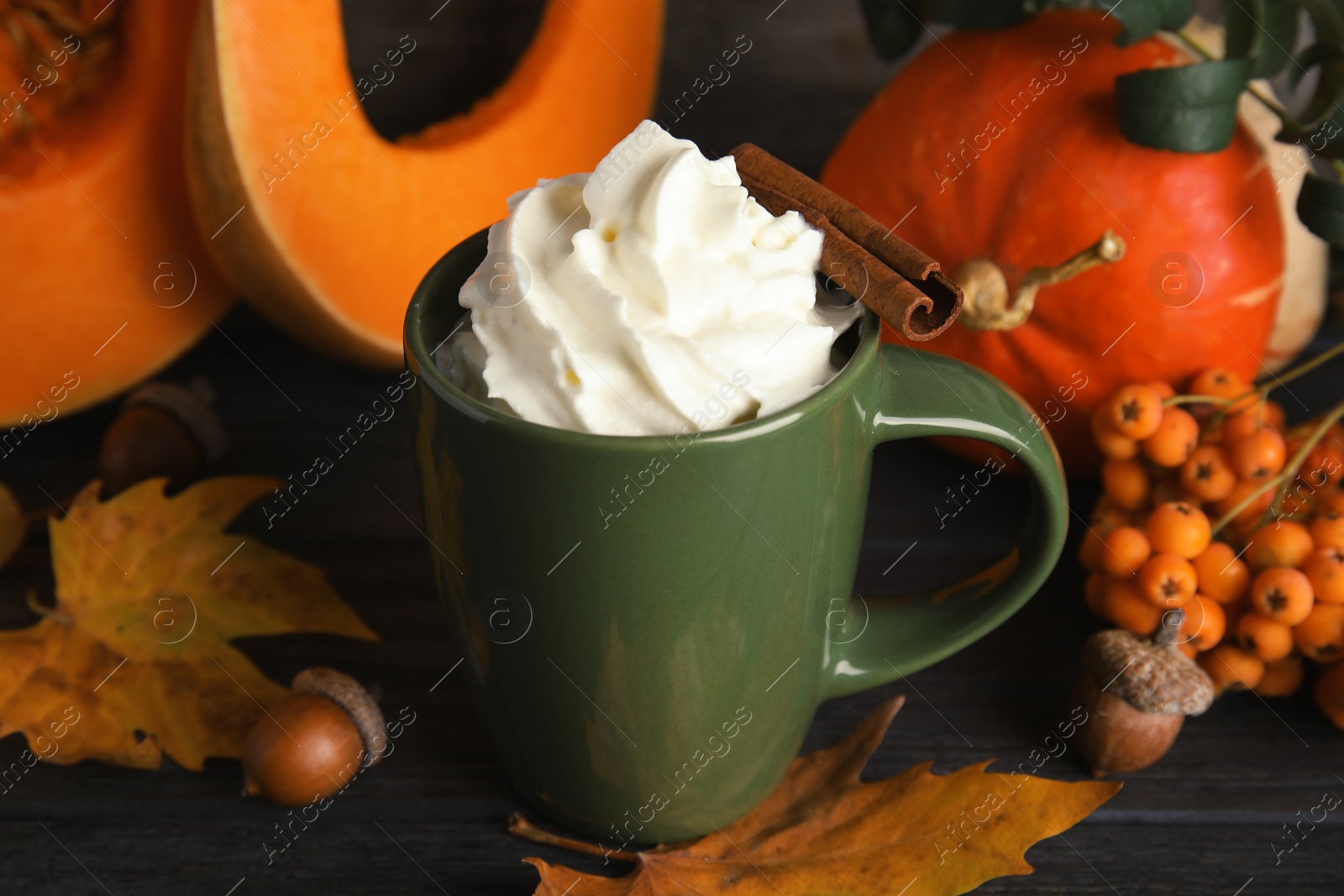 Photo of Composition with pumpkin spice latte  in cup on wooden table