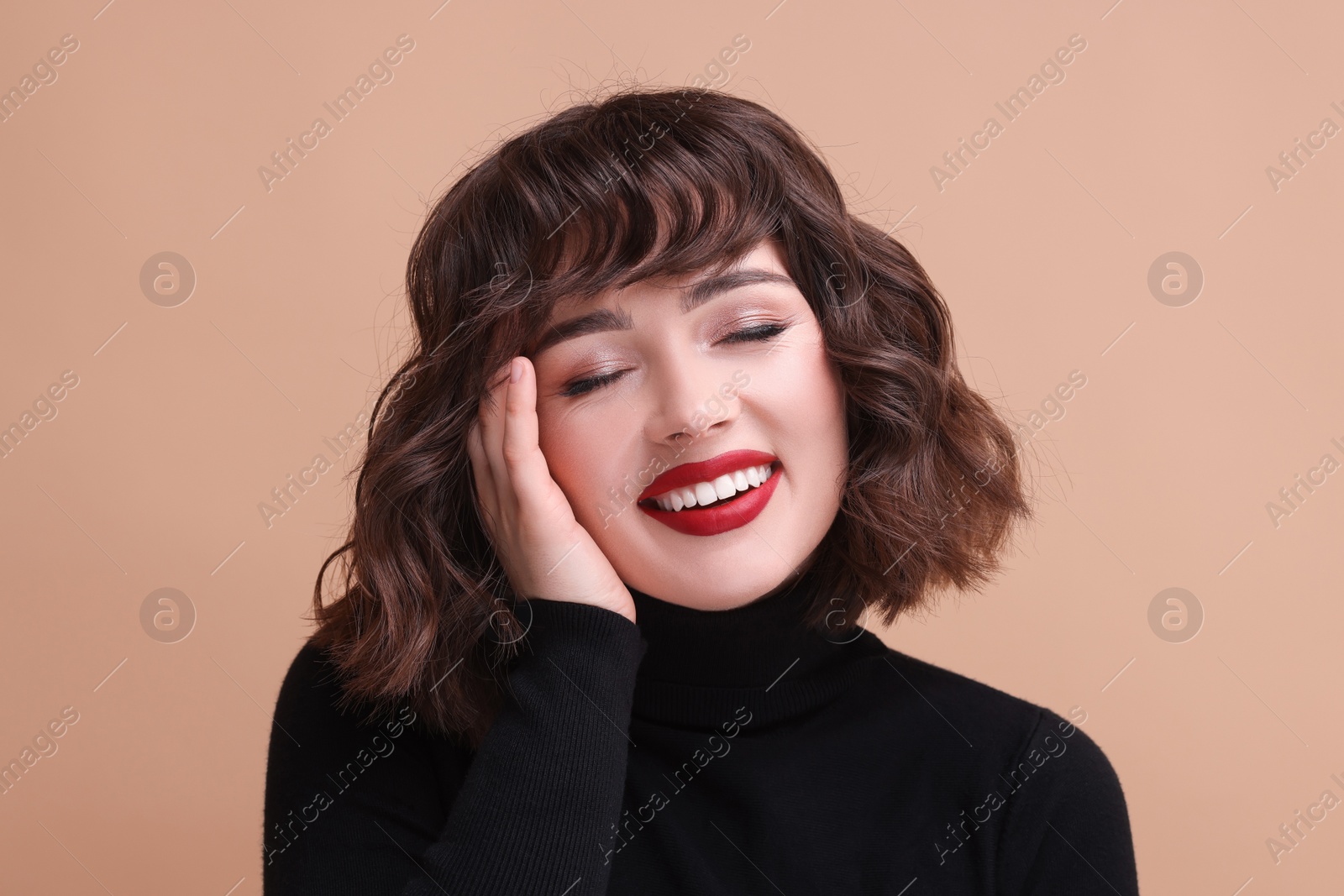 Photo of Portrait of beautiful young woman with wavy hairstyle on beige background