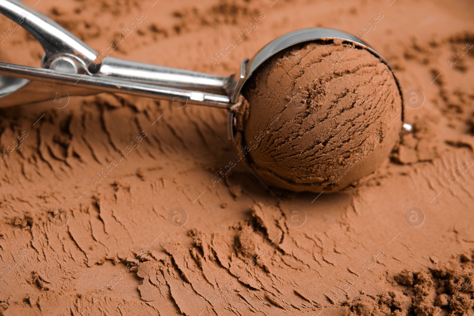 Photo of Scoop with ball on chocolate ice cream, closeup. Space for text