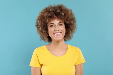 Photo of Woman with clean teeth smiling on light blue background