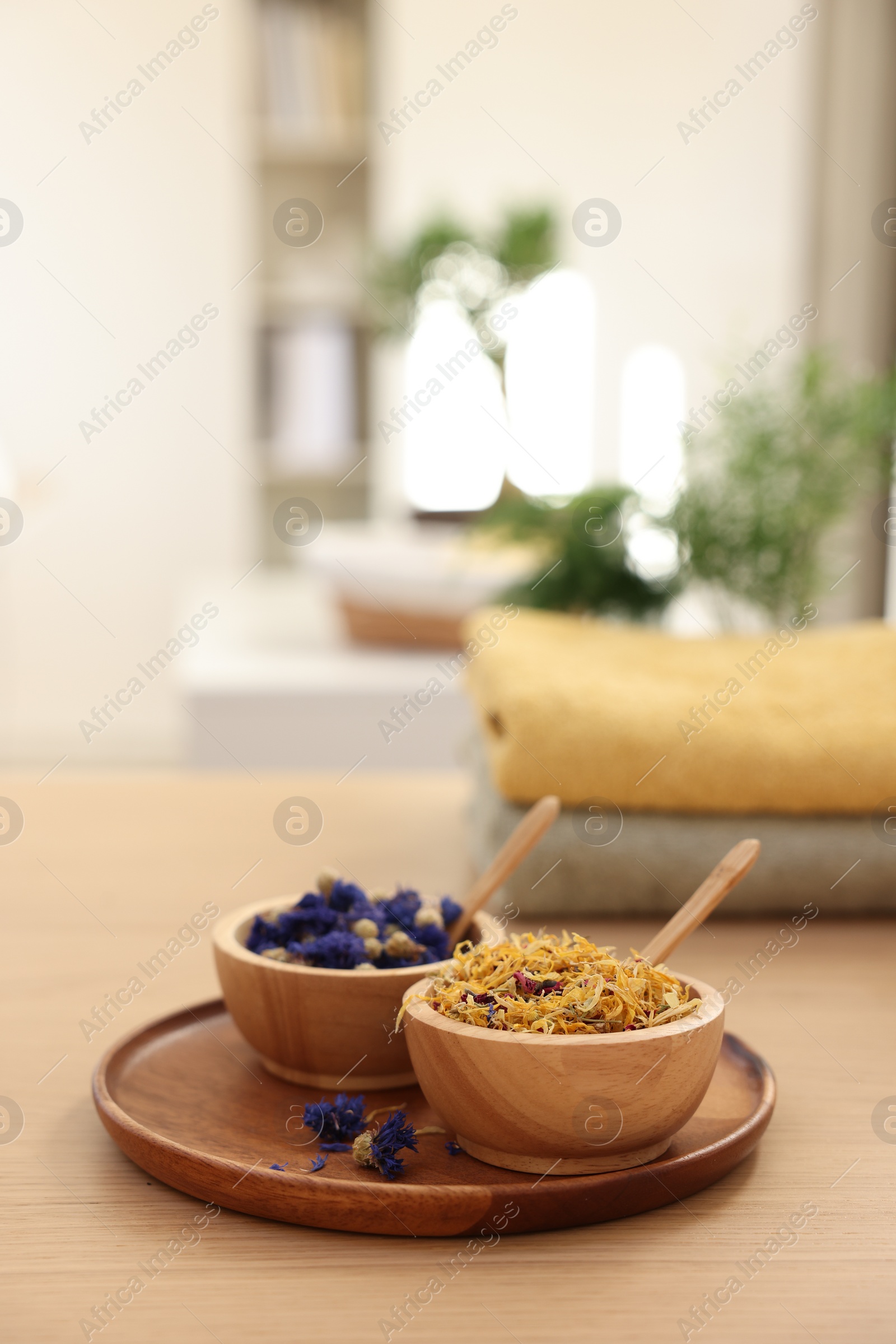 Photo of Dry flowers on wooden table indoors, space for text. Spa time