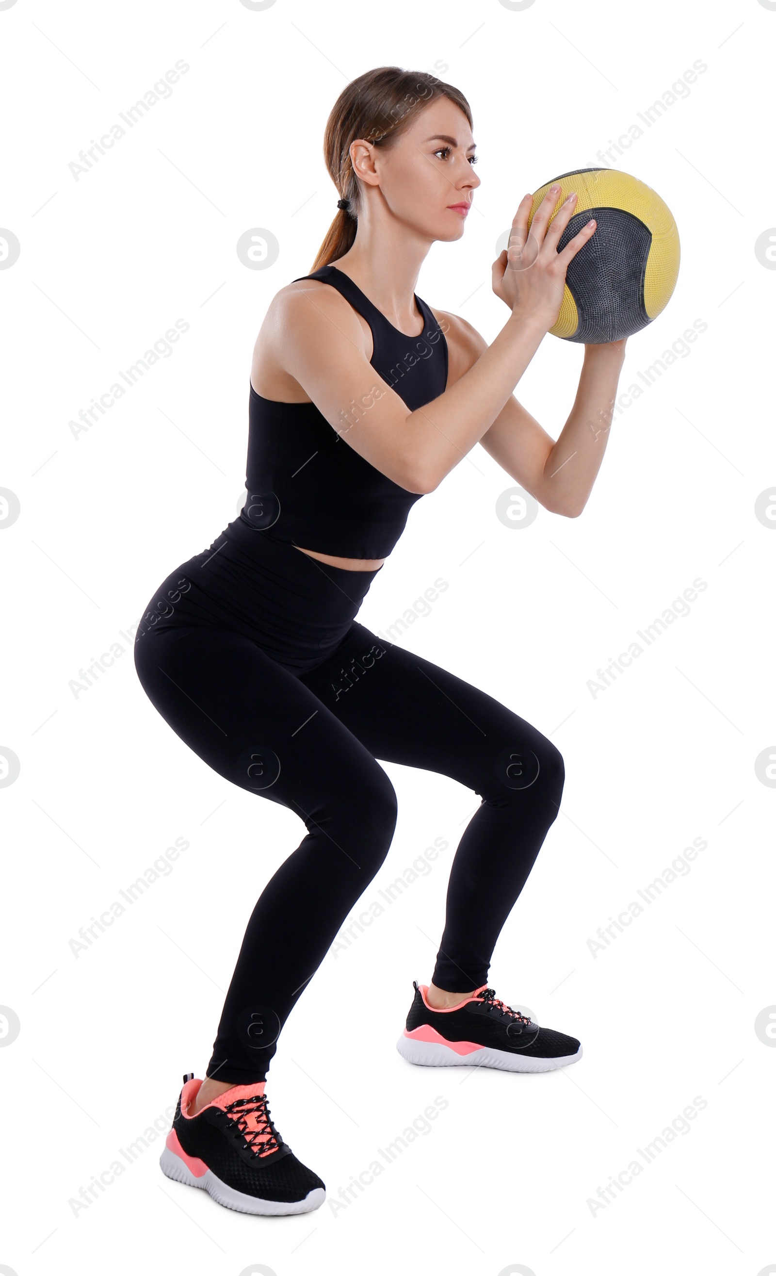 Photo of Athletic woman doing squats with medicine ball isolated on white