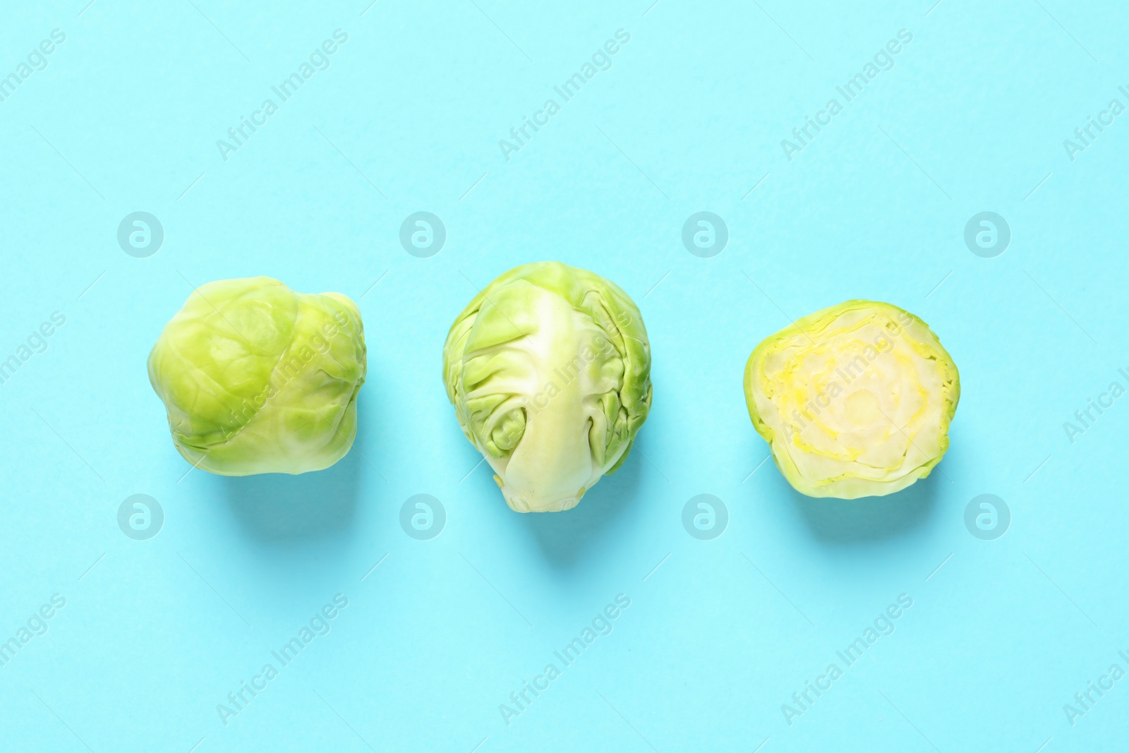 Photo of Fresh Brussels sprouts on color background, flat lay