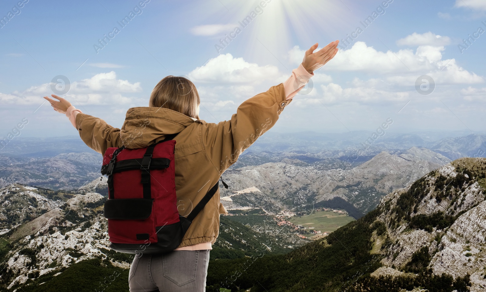 Image of Tourist with travel backpack enjoying mountain landscape during vacation trip