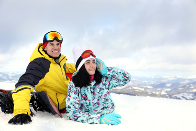 Lovely couple on snowy hill. Winter vacation