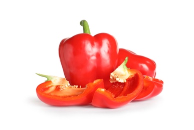 Photo of Cut and whole ripe red bell peppers on white background