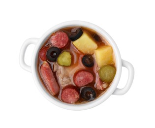 Photo of Meat solyanka soup with thin dry smoked sausages in pot isolated on white, top view