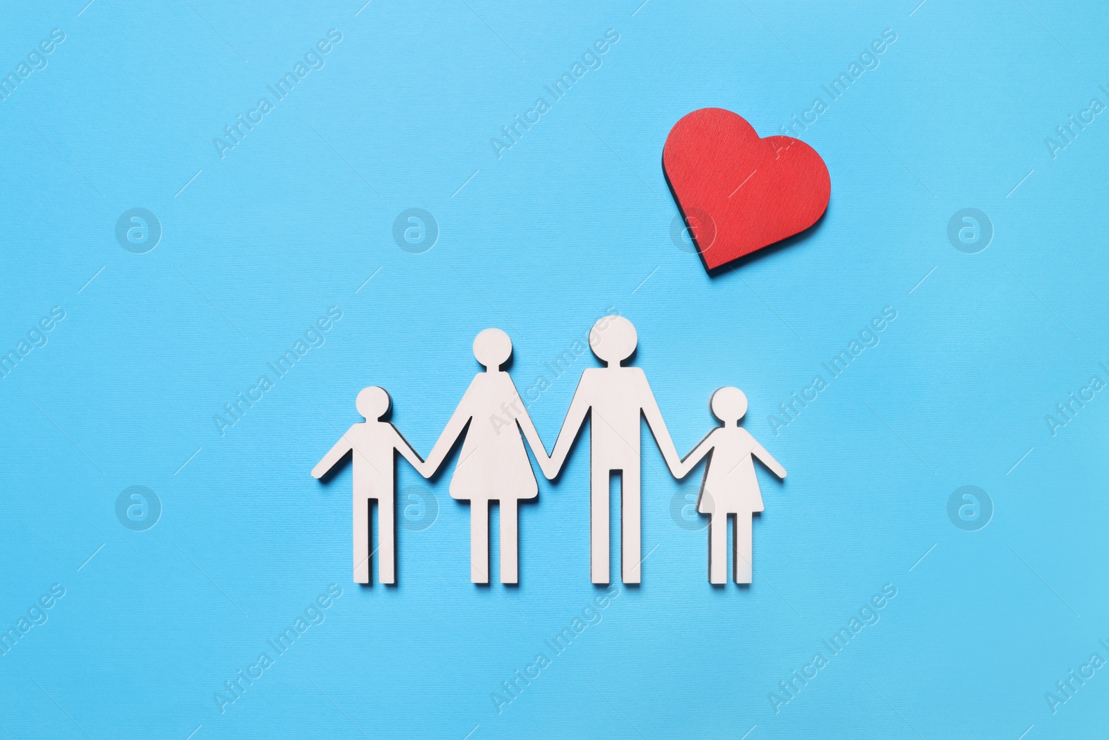 Photo of Figures of family and heart on light blue background, flat lay. Insurance concept