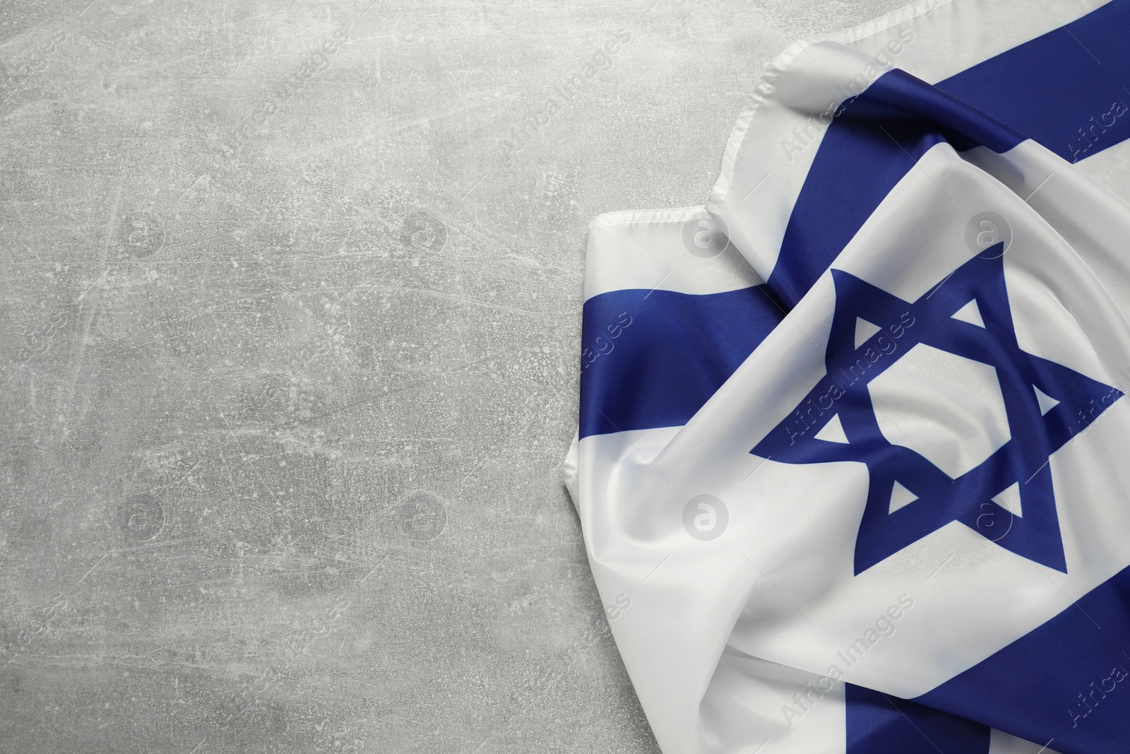 Photo of Flag of Israel on grey textured background, top view and space for text. National symbol