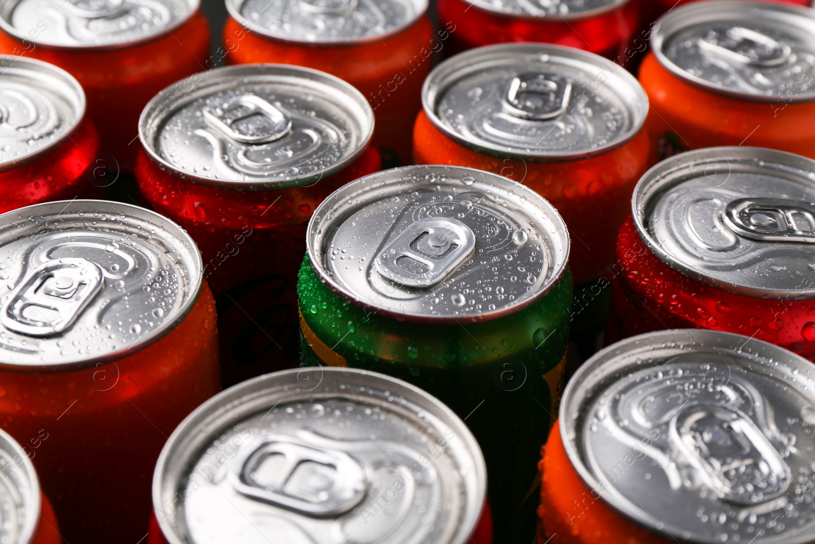 Photo of Energy drink in wet cans, closeup. Functional beverage