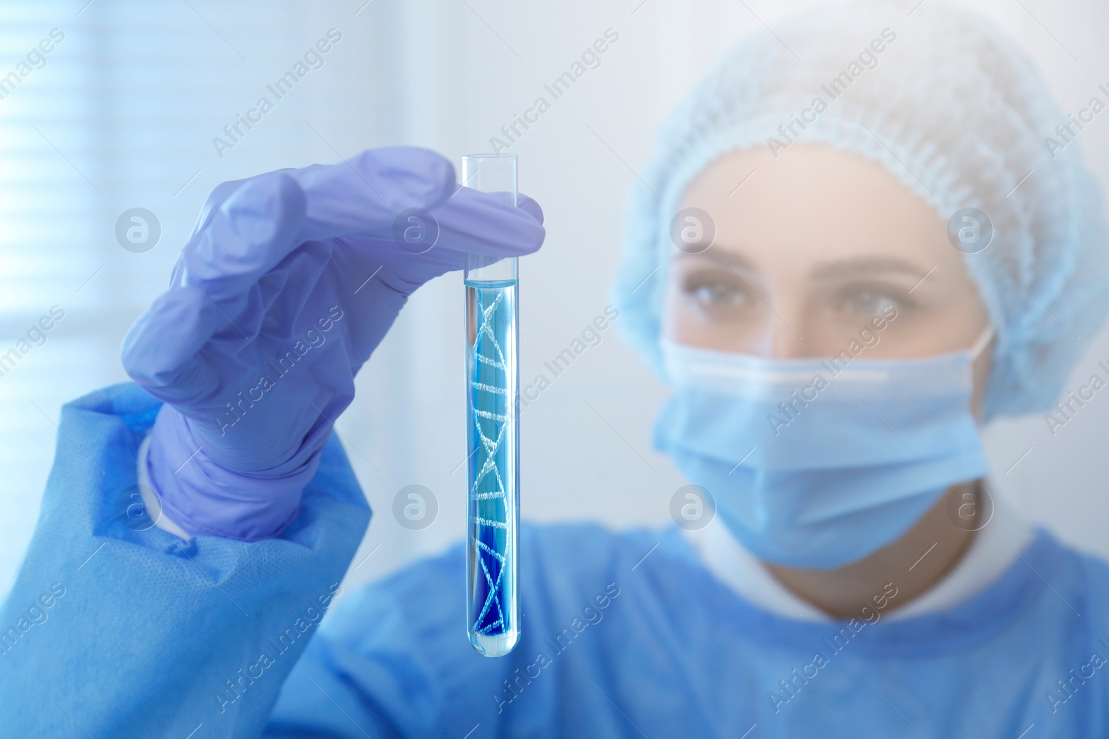 Image of Genetics research. Scientist holding test tube with liquid and illustration of DNA structure in laboratory, selective focus