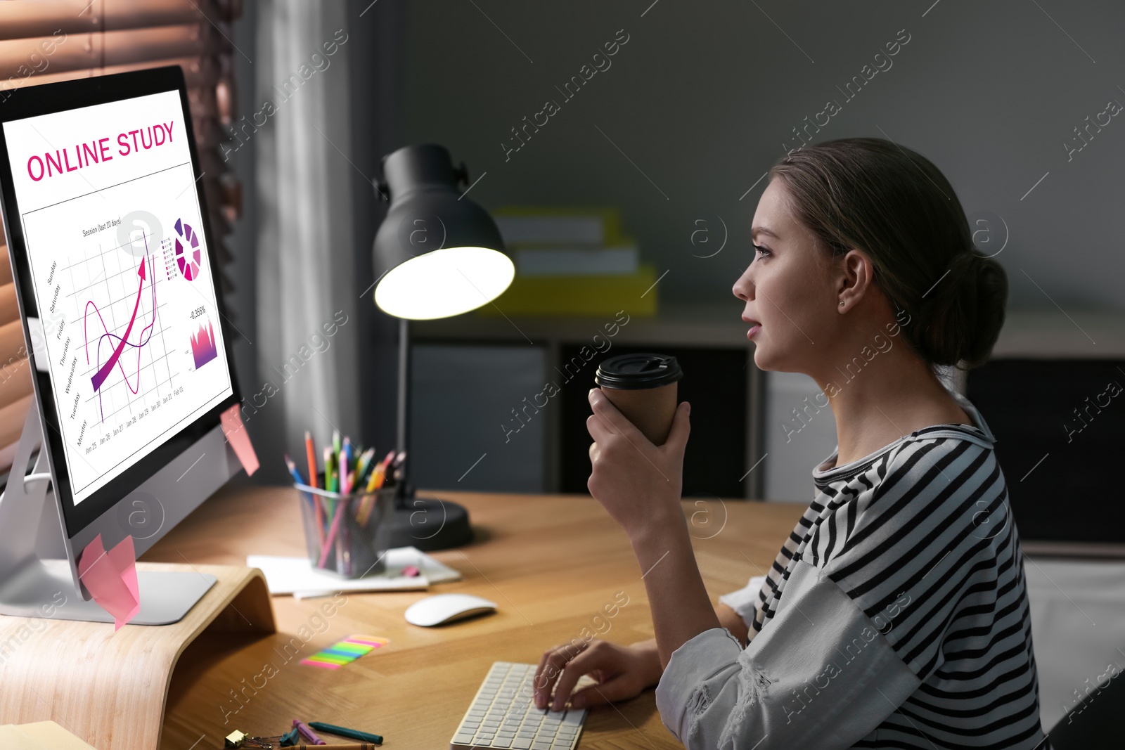 Image of Young woman using laptop for online studying at home