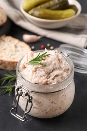 Photo of Delicious lard spread in jar on black table