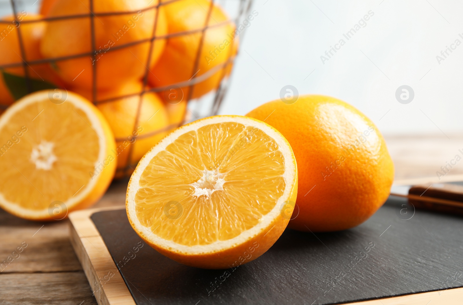 Photo of Fresh juicy oranges on cutting board. Healthy fruit