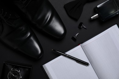 Photo of Flat lay composition with male accessories on black background